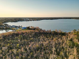Aerial view of a lake surrounded by trees and houses in Dunmanway, West Cork