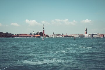 Dramatic shot of St Mark's Campanile in Venice by the river, Italy