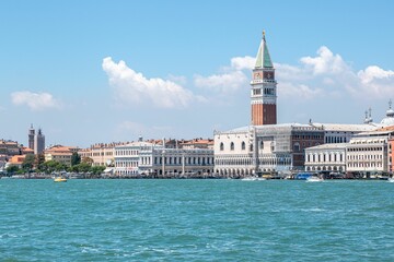 Dramatic shot of St Mark's Campanile in Venice by the river, Italy