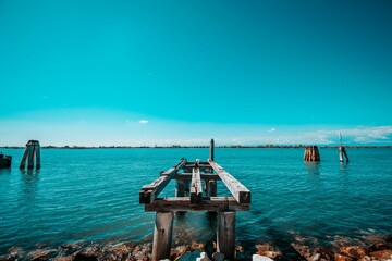 Scenic shot of a small wooden pier in the sea in Italy