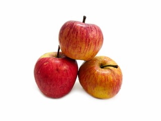 Close-up view of three red apples isolated over a white surface