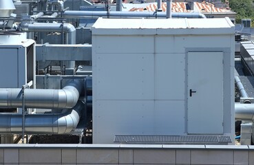 Booth and ventilation system of a building located on the roof against a blue sky