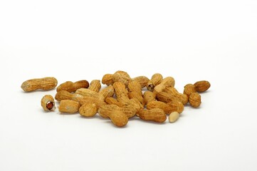 Closeup of a pile of peanuts isolated on a white background with copy space