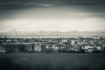 View on the city of Edinburgh, dramatic and dark,seaside from Arhur's seat, sleeping volcano,...