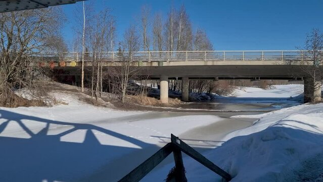 Bridge over the frozen Keravanjoki rive in Vantaa, Finland