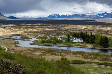 High-angle shot of a Grassland river in with the Thingvellir national park view