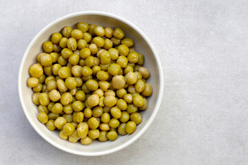 Canned green peas on white background.