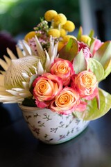 Closeup of a tropical bouquet with roses on a table