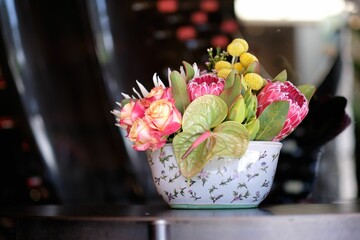 Closeup of a tropical bouquet with roses on a table