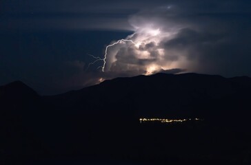 Silhouette of hills during the lightning