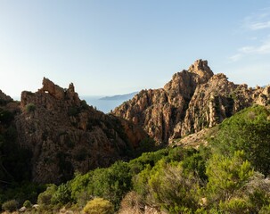 Beautiful landscape of rocky hills with dense foliage on the sunrise