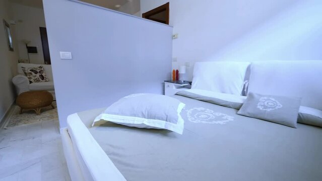 Nice warm interior of a bed and breakfast kitchen, living room and bedroom with white walls