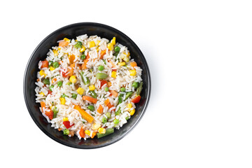 White rice with vegetables in a black bowl isolated on white background. Top view. Copy space - 781977525