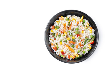 White rice with vegetables in a black bowl isolated on white background. Top view. Copy space - 781977573