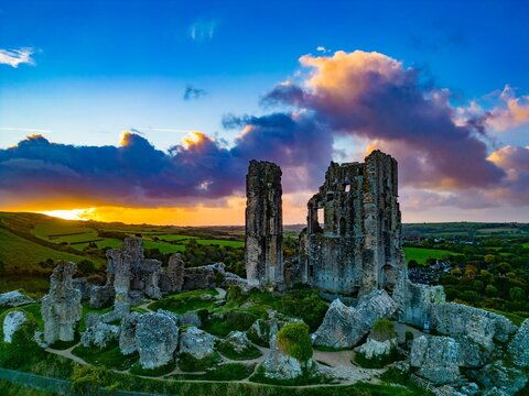 Aerial shot of an old ruins of Corfe Castle, Dorset during sunset