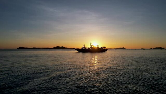 Traditional philippine boat bangka at sunset time in Linapacan, Philippines. Orange sky sunset paradise beach.