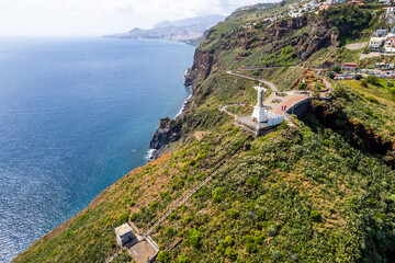 Jesus Christ Statue of Christ the King in Garajau (Cristo Rei ) near Funchal. Aerial drone view - 781983999