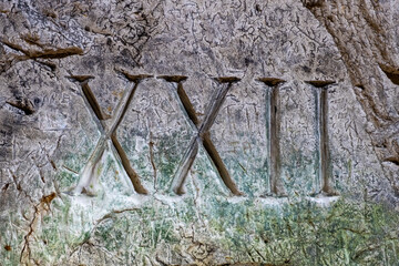 XXII ( 22 ) Roman Numerals Carved Into The Limestone Walls In The Tunnels Of The Hellfire Cave, West Wycombe