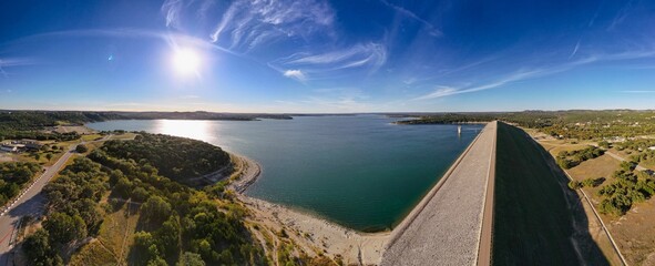 Panoramic shot of roads and fields around a coast on a sunny day