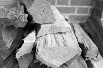 Grayscale closeup of  a stack of split firewood