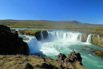 Aerial view of Godafoss waterfall shot in long exposure in Iceland on a sunny day