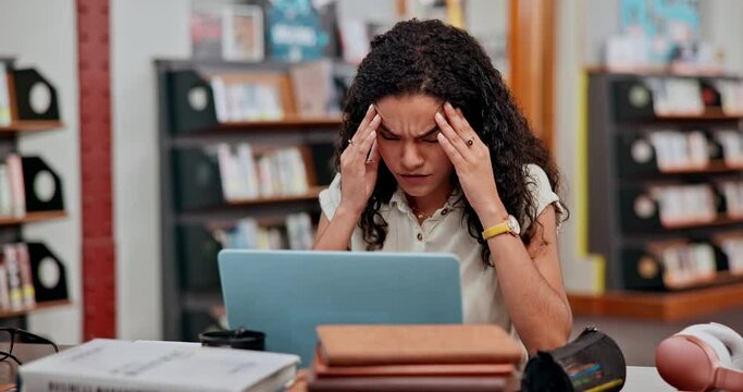 Stress, headache and woman student with laptop in library studying for exam, assignment or test. Migraine, burnout and female person with university research online with computer for education.