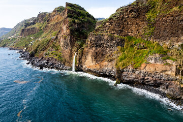 Waterfall fall into Atlantic Ocean in Madeira Island, Portugal. Aerial Drone view - 781990125