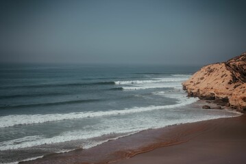Fototapeta na wymiar Beautiful shot of ocean waves covering a sandy beach