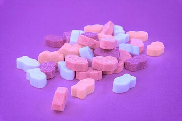 Closeup of colorful sweets in purple background