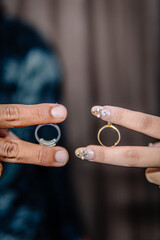 A pair of man and woman are showing their wedding rings