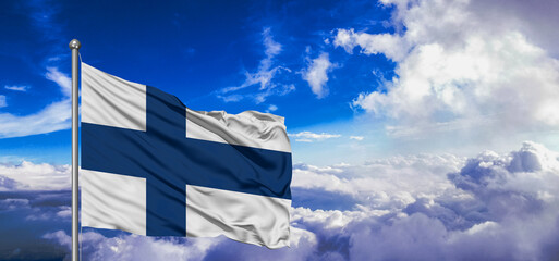 Finland national flag cloth fabric waving on beautiful Blue Sky Background.