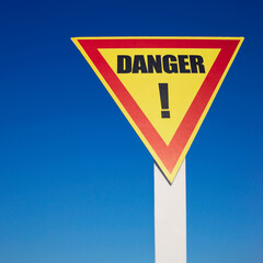 Danger sign on blue sky