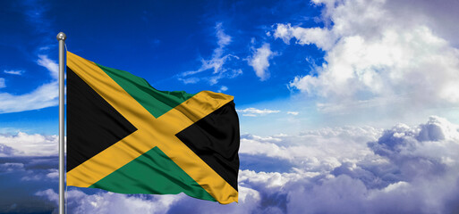 Jamaica national flag cloth fabric waving on beautiful Blue Sky Background.