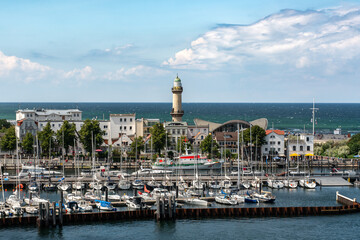 View of the Warnemünde lighthouse. In the foreground is the Warnemünde boat harbor. Warnow...