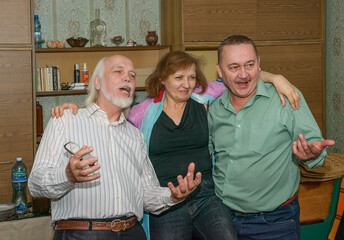 Group portrait of three elderly people in home interior, Ukraine.