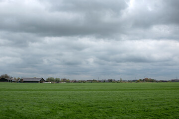 Fototapeta na wymiar Large Farmland With In The Background A Farmhouse At Abcoude The Netherlands 8-4-2024