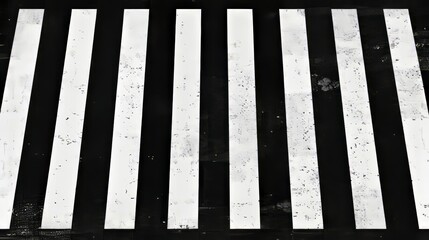 View from above of pedestrian crossing on a city street. Modern background of black asphalt surface with white zebra lines.