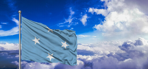 Micronesia, Federated States of Micronesia national flag cloth fabric waving on beautiful Blue Sky Background. - obrazy, fototapety, plakaty