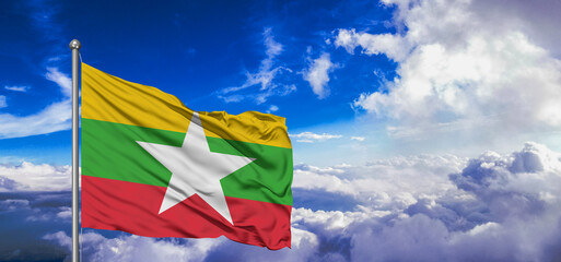 Myanmar (Burma)  national flag cloth fabric waving on beautiful Blue Sky Background.