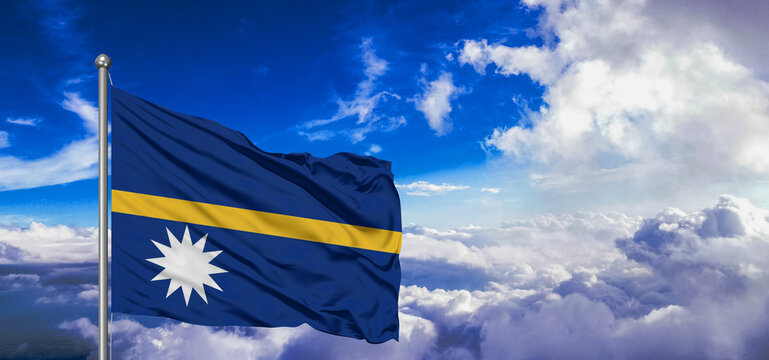 Nauru national flag cloth fabric waving on beautiful Blue Sky Background.