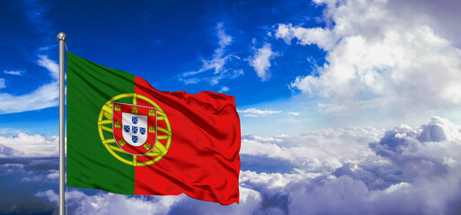 Portugal national flag cloth fabric waving on beautiful Blue Sky Background.