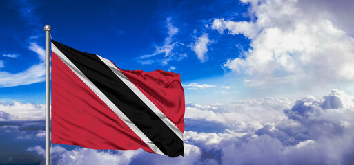 Trinidad and Tobago national flag cloth fabric waving on beautiful Blue Sky Background.