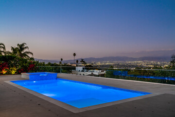 Brightly lit pool under a starry night sky in Encino, California