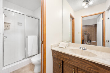 Bathroom with toilet, sink, and mirror in Encino, California