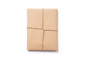 Top view of wrapped book, cardboard paper and twine on white background