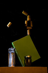 unlikely balance (corks, book, black background)