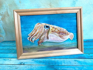 picture of a cuttlefish in a wooden frame on a blue background