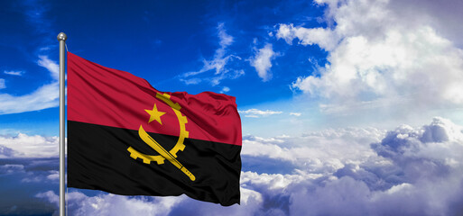 Angola national flag cloth fabric waving on beautiful Blue Sky Background.