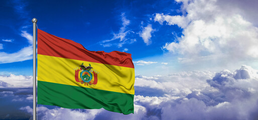 Bolivia national flag cloth fabric waving on beautiful Blue Sky Background.