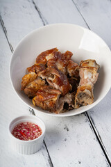 crispy pata or deep fried pork leg with a sweet white vinaigrette sauce, it is a well known food in the Philippines 